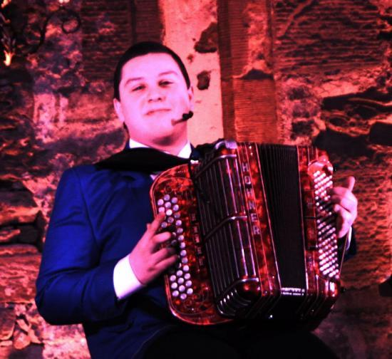 Photograph of Brandon buttons up the Scottish accordion championship