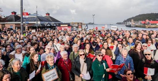 Photograph of Mòd Eireachdail An Òbain A' Còrdadh Ris Na Mìltean Agus A' Bhratach A' Dol Gu Loch Abar Air- Son 2025 Thousands enjoy magnificent Oban Mòd as flag is passed to Lochaber for 2025   